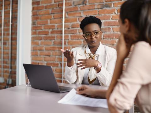 African American woman with glasses interviewing for a job.